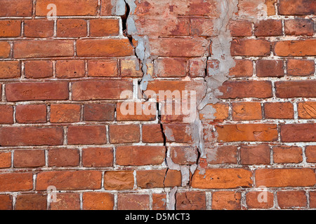 Old weathered red brick wall as background Stock Photo