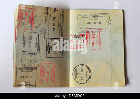 Fully stamped Visa pages in a Passport. Stock Photo