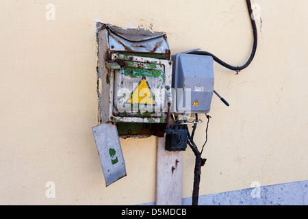 Old rusty electrical switch on the wall Stock Photo