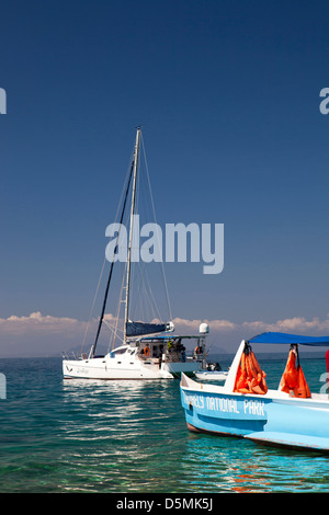 Madagascar, Nosy Be, Nosy Tanikely, main beach, catamaran and national park boat Stock Photo