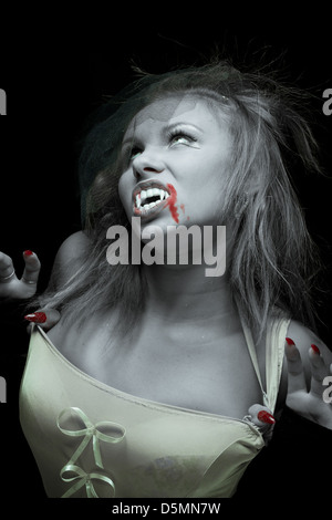 woman vampire with fangs on a black background Stock Photo