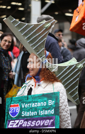 A woman wearing a model of a New York City bridge as a hat in New York City's Easter Parade Stock Photo
