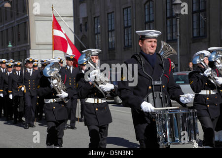 Copenhagen, Denmark. April 4th 2013. The  playing and singing Royal Danish Navy Band accompanying the cadets from the Royal Danish Naval Academy on their  'Flag on Board' parade through the city to parade the flag on board the naval training ships to mark the beginning of the new sailing season. Stock Photo