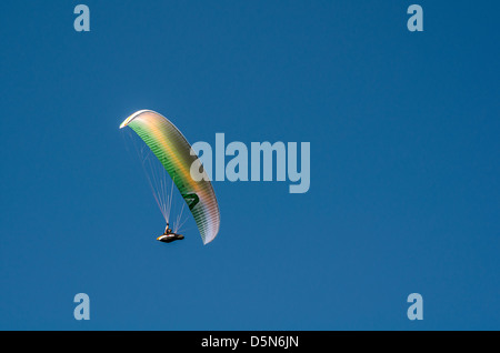 Hang gliding enthusiasts take the the skies creating a graceful spectacle at Stanwell Tops, Australia. Stock Photo