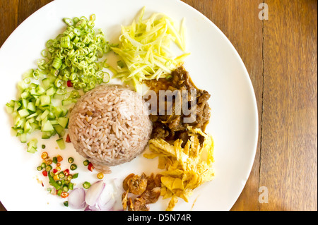 A dish of rice mixed with shrimp paste serve with omelet, pork and various vegetable. Stock Photo