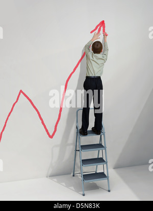 boy draws a graph on the wall Stock Photo