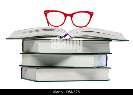 red glasses on open book, pile or stack of books isolated over white background Stock Photo