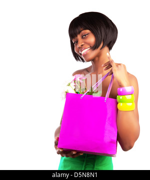 Cute American girl holding in hands pink shopping bag with fresh flowers isolated on white background, money spending concept Stock Photo
