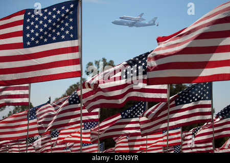 The final flight of the Space Shuttle Columbia flies on 9/21/12 over US Flags at Peperdine University in Malibu, CA Stock Photo
