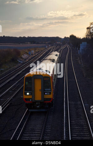 Worting, Hampshire, UK. 5th April 2013 A South West Trains evening commuter service from Salisbury passing Worting Junction in Hampshire, en-route to London Waterloo.  Credit: Rob Arnold/Alamy Live News Stock Photo