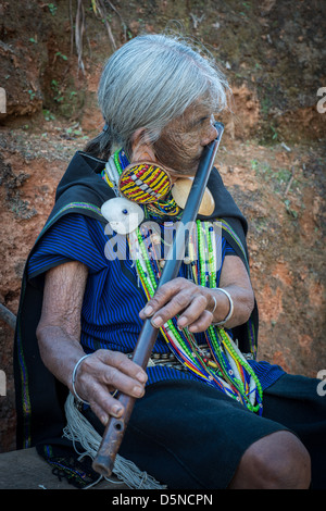 K'Cho Chin woman playing the nose flute Stock Photo