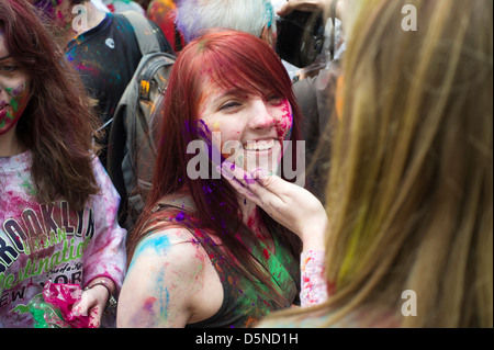 Colored powder is applied to the faces of participants as they celebrate the Indian holiday of Holi Stock Photo
