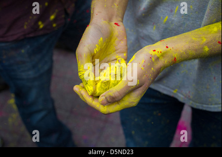 Colored powder is applied to the faces of participants as they celebrate the Indian holiday of Holi Stock Photo