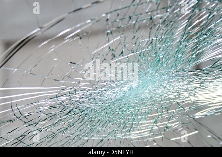 spiderweb-pattern cracks in a smashed windshield Stock Photo