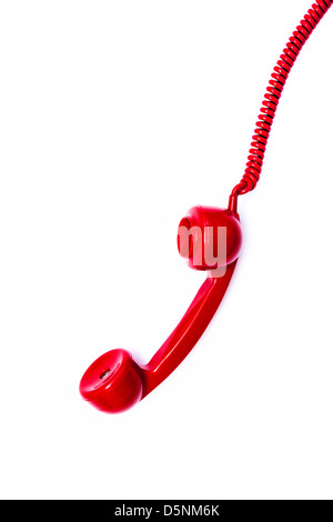 Red retro style telephone receiver and cord. Stock Photo