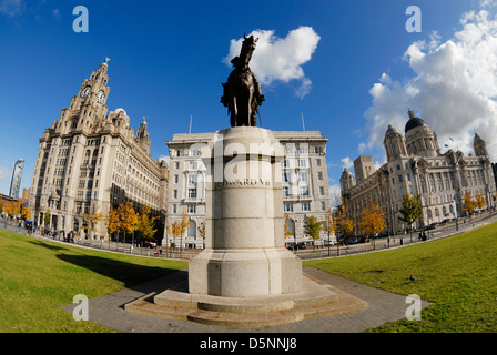 Statue of Edward VII in front of the iconic three Graces at Pier Head, Liverpool, a UNESCO World Heritage site. Stock Photo