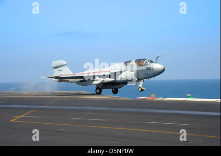 A US Navy EA-6B Prowler aircraft lands aboard the aircraft carrier USS Dwight D. Eisenhower April 3, 2013 in the Arabian Sea. Stock Photo