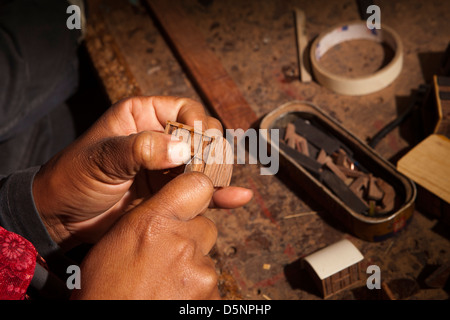 Madagascar, Antananarivo, Crafts, Le Village model boat making workshop, craftsman’s hands Stock Photo