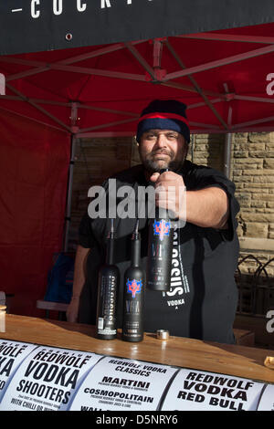 RedWolf Vodka for sale n Blackpool, Lancashire,UK Saturday April 6th 2013. Mr Alexander Mustang 44, from London, event organiser at the Great Blackpool Chilli Festival in the beautiful revamped St Johns Square, an landmark  event organised by Chilli Fest UK. The venue owners Blackpool Bid are keen to make Blackpool Chilli Festival one of its main attractions during the peak holiday season.  Blackpool’s first ever Chilli Festival held in St John’s Square in the heart of the town centre bringing together chilli producers and traders from all over the UK. Stock Photo