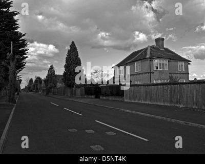 Black and white view of straight road, Wellingborough, Northamptonshire, England, United Kingdom Stock Photo