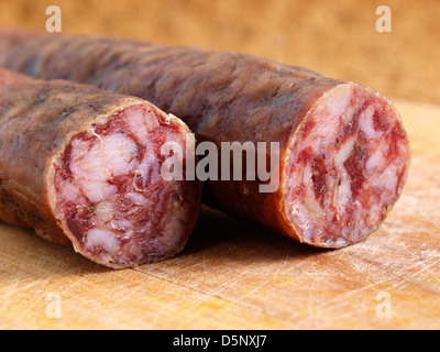 Spanish salami close up on a wood board Stock Photo