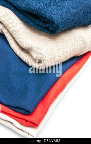 Pile of colorful warm clothes on wooden background Stock Photo - Alamy