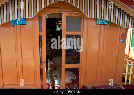 Kashmir, India. 6th April 2013. A policeman enters  the houseboat where a British woman was allegedly  murdered by a Dutch tourist on Saturday in Srinagar, the summer capital city of Indian-administered Kashmir. 24-year old  Sara Elizabeth was found in a pool of blood inside her room in the houseboat in the morning,  police said, adding she might have been raped before being killed as her clothes were torn. Dutch tourist Davit Rechord (43), who was staying in another room of the houseboat has been arrested. Credit: yawar nazir kabli / Alamy Live News Stock Photo