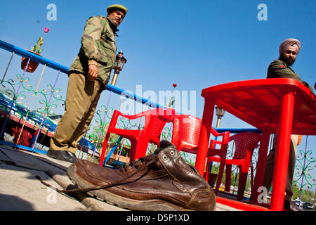 Kashmir, India. 6th April 2013. Policemen look at the shoes of  Dutch tourist  Davit Rechord , accused of having murdered a British woman in a houseboat in Srinagar, the summer capital city of Indian-administered Kashmir.  24-year old  Sara Elizabeth was found in a pool of blood inside her room in the houseboat in the morning,  police said, adding she might have been raped before being killed as her clothes were torn.  Rechord (43), who was staying in another room of the houseboat was arrested. Credit: yawar nazir kabli / Alamy Live News Stock Photo