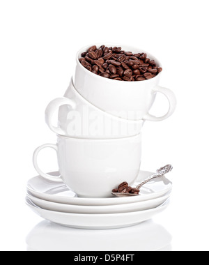 Stack of clean white crockery filled with coffee beans Stock Photo