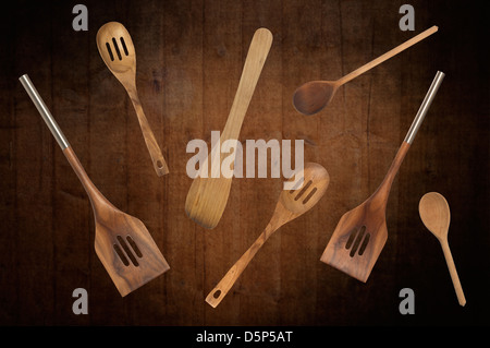 Selection of kitchen spoons for cooking on abstract wooden background Stock Photo