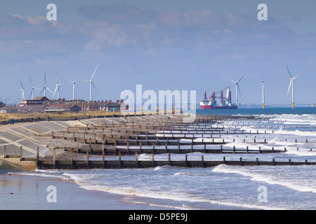 Six wind turbines in the Redcar Farm dominate the skyline above the town while construction continues offshore Stock Photo