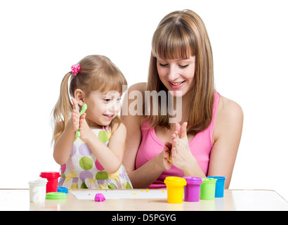 kid girl and mother playing colorful clay toy Stock Photo