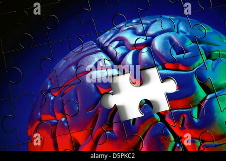 A piece missing from a jigsaw puzzle made from a photograph (with coloured flash) of a plastic model human brain. Stock Photo