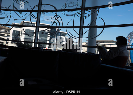 elderly couple having coffee silhouetted Stock Photo