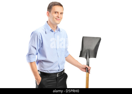 A young man holding a shovel isolated against white background Stock Photo