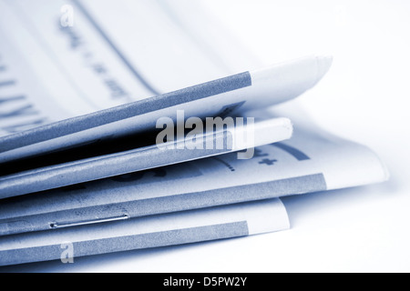 Folded newspapers on brown wooden table Stock Photo