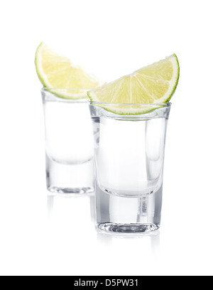 Two shots of vodka and lime slice. Isolated on white background Stock Photo