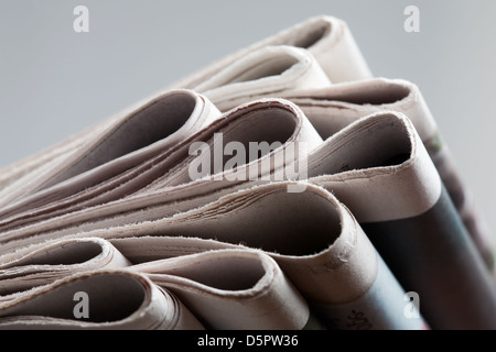 Folded newspapers on brown wooden table Stock Photo