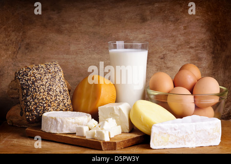 still life with dairy products, milk, eggs, bread and chees on a vintage wooden background Stock Photo