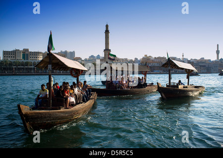 Traditional Abra water ferries crossing The Creek at Deira in Dubai United Arab Emirates Stock Photo