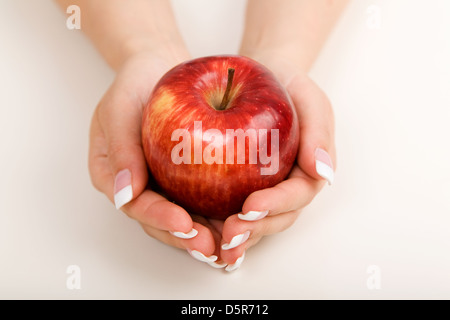 Young woman holding red apple in her hands Stock Photo