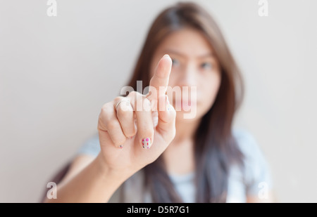 asian woman pressing an imaginary button empty space for buttons Stock Photo