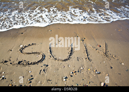 the word Marbella written in the wet sand  at the beach Stock Photo