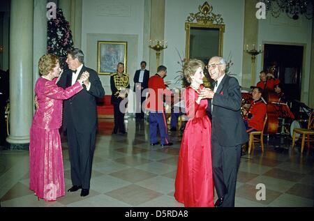 File pics: United States President Ronald Reagan and Prime Minister Margaret Thatcher of Great Britain share a dance in the Entrance Hall of the the White House in Washington, D.C. following the dinner in her honor on Wednesday, November 16, 1988. At right their spouses, first lady Nancy Reagan and Denis Thatcher share a dance as well. Thatcher died from a stroke at 87 on Monday, April 8, 2013. Credit: Ron Sachs / CNP/Alamy Live News Stock Photo