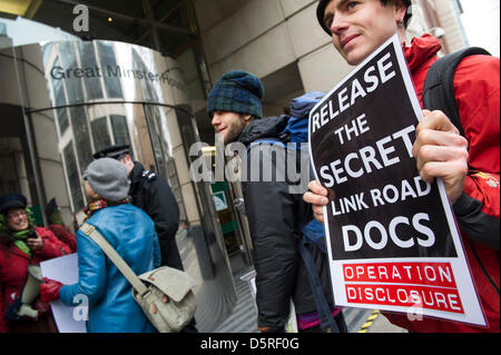 London, UK. 8th April 2013. Operation Disclosure -  Erica, a resident of St Leonards (pictured in blue coat), is the only protestor to gain access to deliver her letter for Norman Baker, Minister of transport.  Anti-road campaigners, known as the Combe Haven Defenders stage a peaceful two-day ‘search’ of the Department for Transport (DfT) for its recommendations about the £100m Bexhill-Hastings Link Road – they have a copy of a document with the key conclusions redacted, but the body of the document is not very supportive of the proposed scheme.The ‘searchers’ attempted to enter the building b Stock Photo
