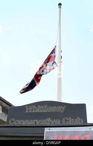 Whittlesey, Cambridgeshire, UK. 8th April 2013. Death of Margaret Thatcher announced       Flag flies at halfmast,       April 8, 2013            As soon as the death of former Prime Minister Baroness Margaret (Maggie) Thatcher, was announced, Kim Ingram, manager of the Conservative Club in Whittlesey, Cambridgeshire, got staff member Steve Purvis to lower the Union Flag to halfmast. Pic: Paul Marriott Photography/Alamy Live News Stock Photo