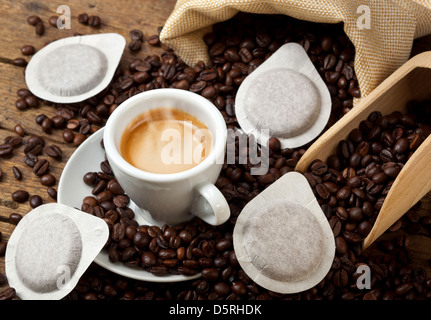 Coffee cups with pods on rustic table Stock Photo
