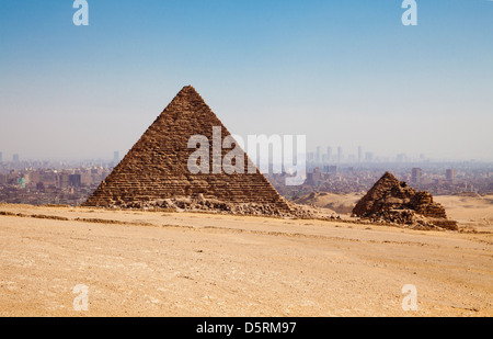 The Pyramid of Menkaure and the Pyramids of the Queens with Cairo behind in Egypt Stock Photo