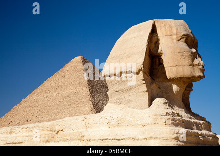 The Great Sphinx with the Great Pyramid of Khufu behind at Giza in Egypt Stock Photo