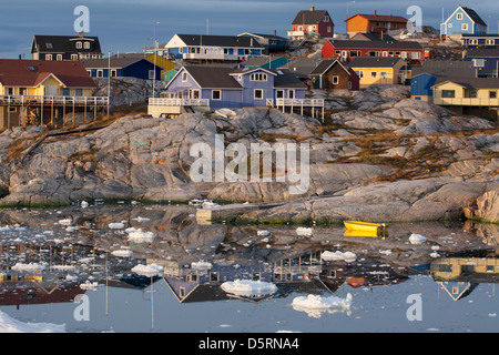 Colourful wooden houses by sea with iceberg fragments, Ilulissat (Jakobshavn), Greenland Stock Photo